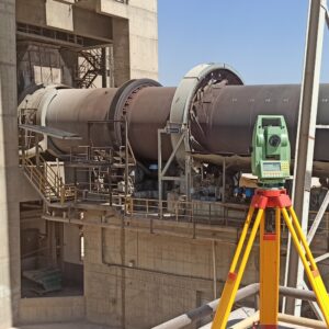 Hot kiln alignment measurements being taken on a rotary kiln for precise axis alignment and performance optimization.