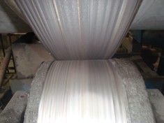 Wear pattern on rotary kiln tire and roller caused by incorrect alignment, leading to uneven wear and reduced efficiency.