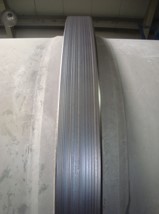 Worn tire surface of a rotary kiln ring caused by improper alignment, resulting in uneven wear and reduced operational efficiency.